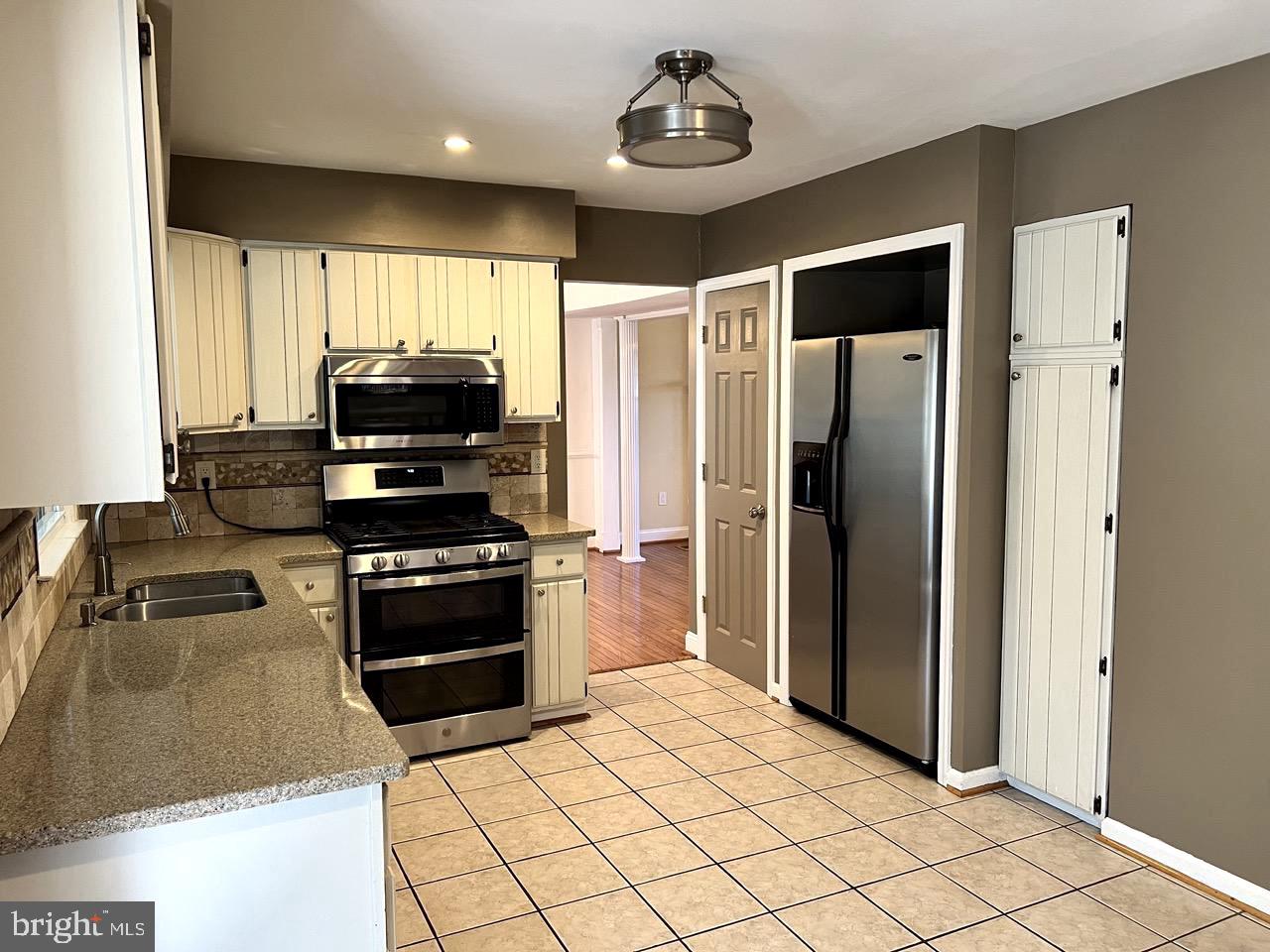 3502 Old Jones Road Dunkirk, MD 20754 - Photo 10 of 61 a kitchen with stainless steel appliances a refrigerator and a stove top oven