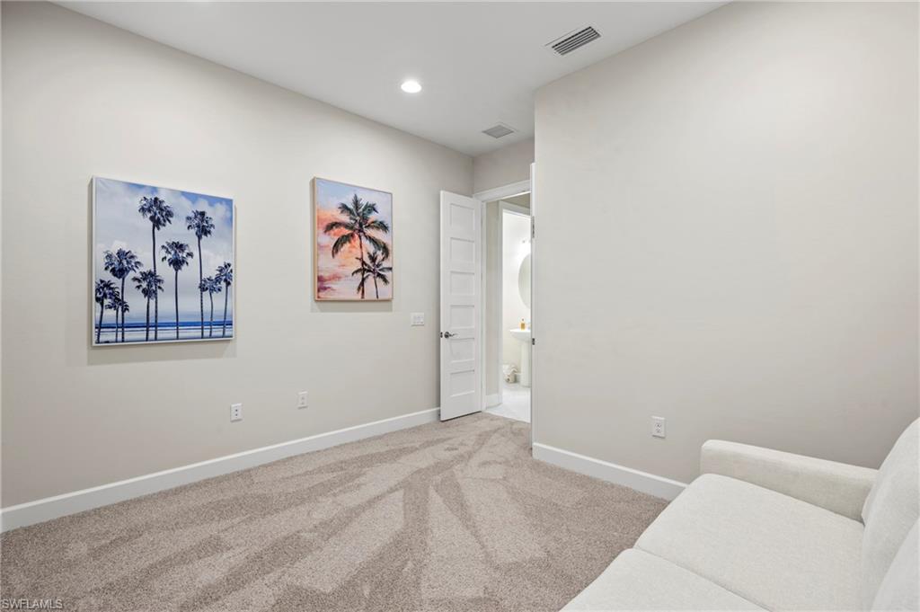 8795 Calypso Court Naples, FL 34113 - Photo 20 of 49 an empty room with wall painting and a window