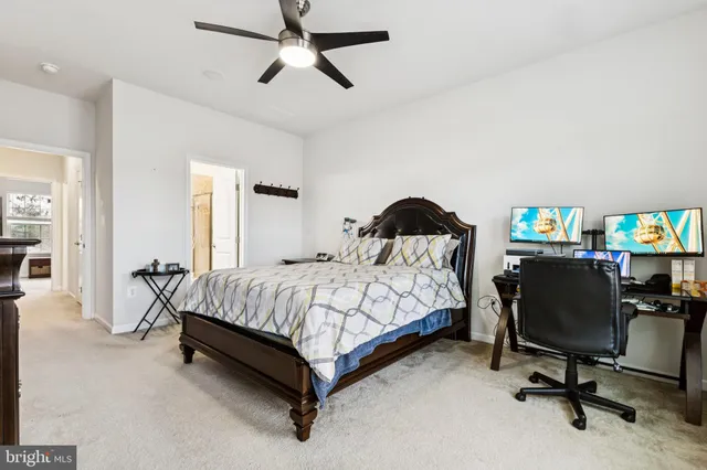 a bedroom with a bed chair and a desk