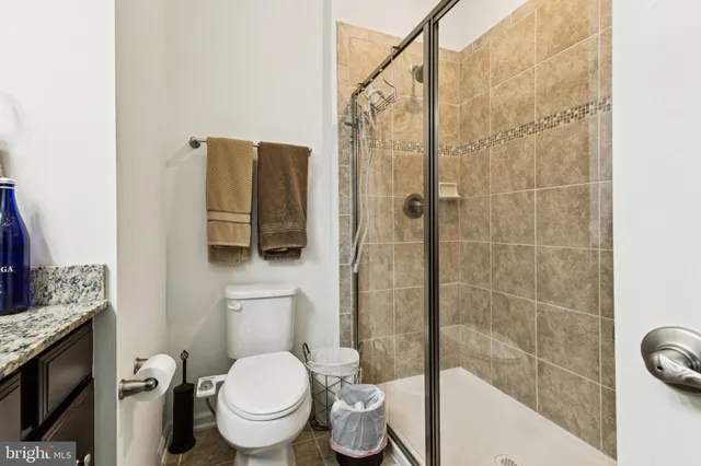 a bathroom with a toilet and a shower