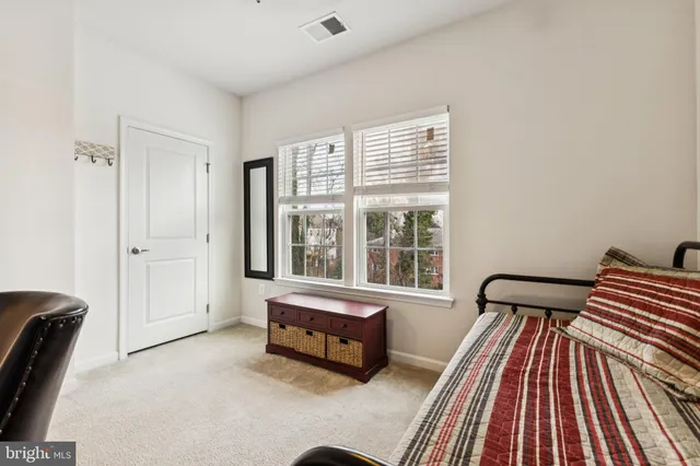 a spacious bedroom with a bed and a window