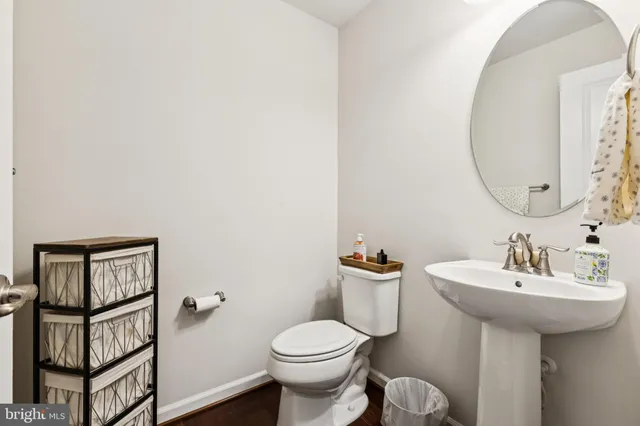 a bathroom with a sink toilet and a mirror