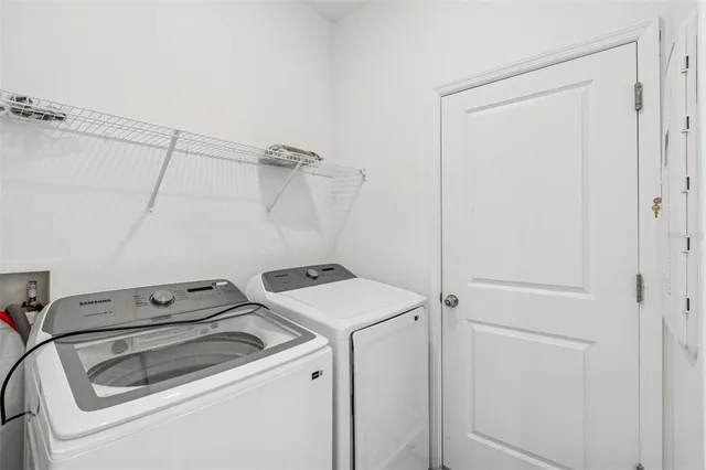 a view of an empty room with closet and a window