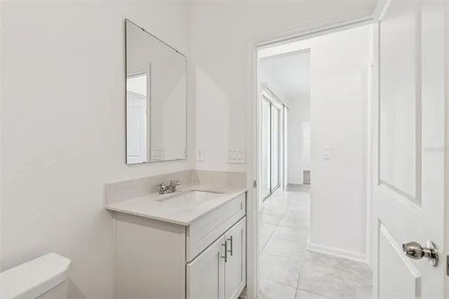 an empty room with a ceiling fan and a window