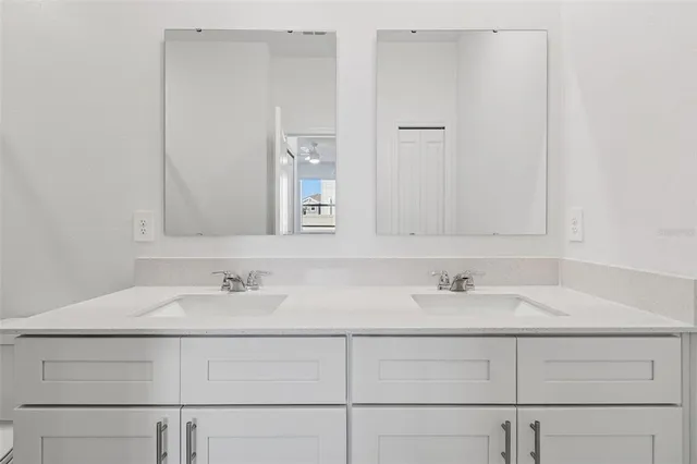 an empty room with closet and a ceiling fan