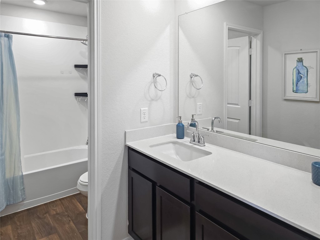 410 Inks Lane Kyle, TX 78640 - Photo 14 of 20 Full bathroom with vanity, shower / bath combo, and dark wood-style flooring
