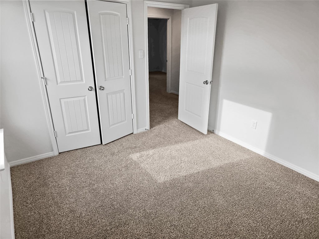 410 Inks Lane Kyle, TX 78640 - Photo 16 of 20 Unfurnished bedroom with light colored carpet and a closet