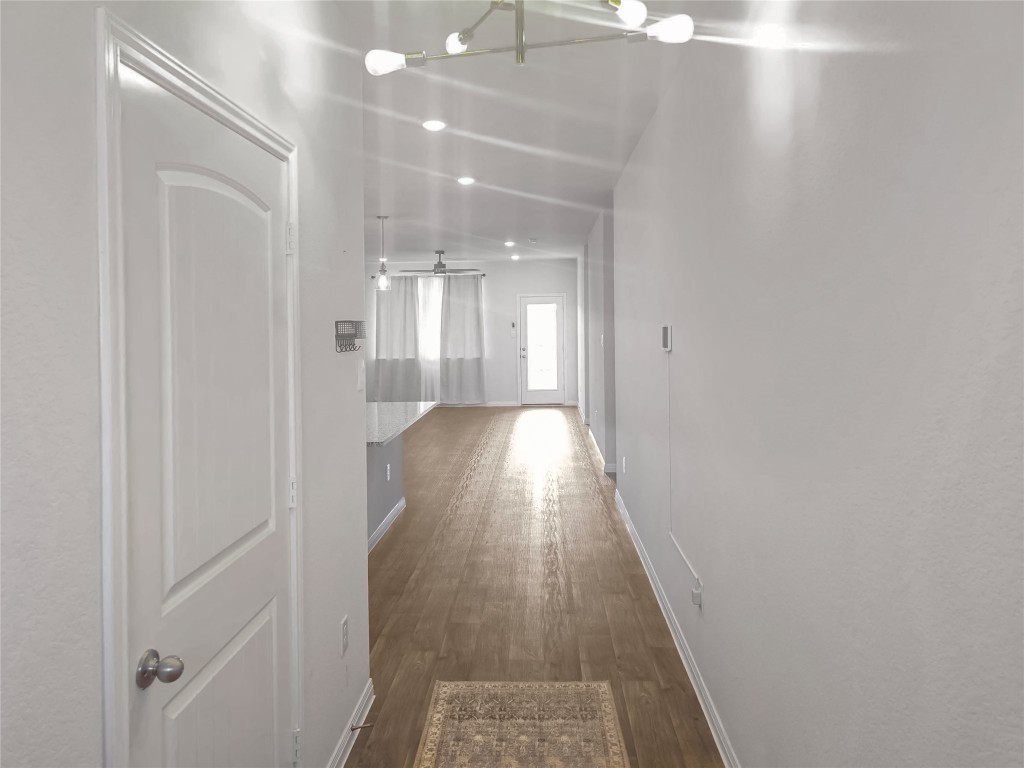 410 Inks Lane Kyle, TX 78640 - Photo 5 of 20 Hallway featuring baseboards and dark wood finished floors