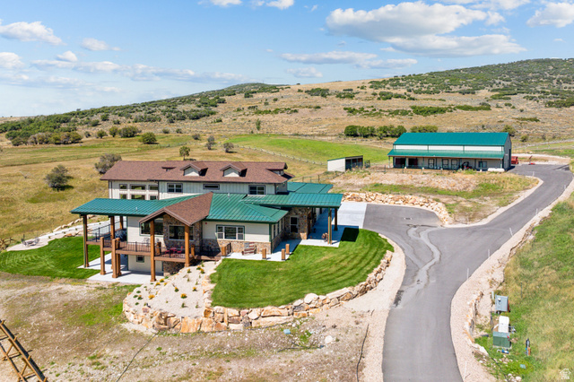 6117 North Rocky Ridge Road Peoa, UT 84061 - Photo 12 of 82 Expansive property featuring a multi-level residence with covered balconies and a green metal roof