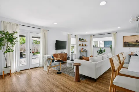 a bedroom with a bed a mirror and a window