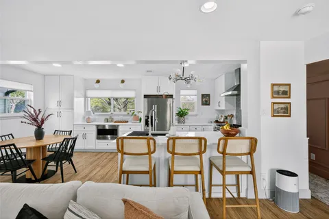 a living room with furniture a flat screen tv and a large window