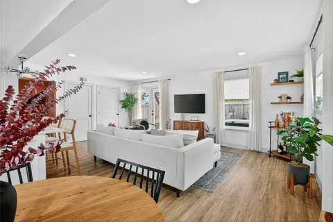 a view of a dining room with furniture and wooden floor
