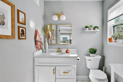 a kitchen with a refrigerator sink and white cabinets