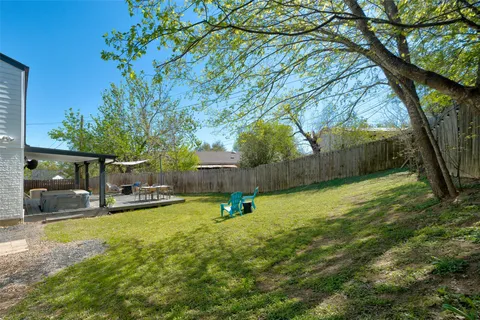 a view of a swimming pool with a chairs in patio