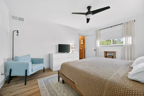 a kitchen with white cabinets and appliances