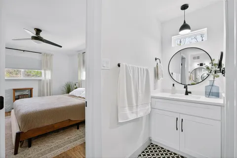 a view of hallway with furniture and wooden floor