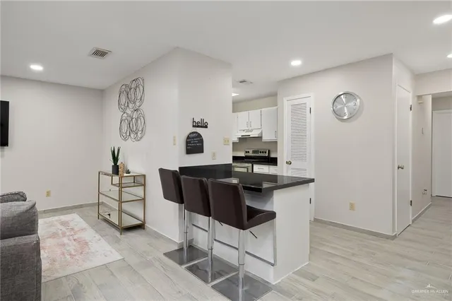 a view of kitchen with cabinets and wooden floor