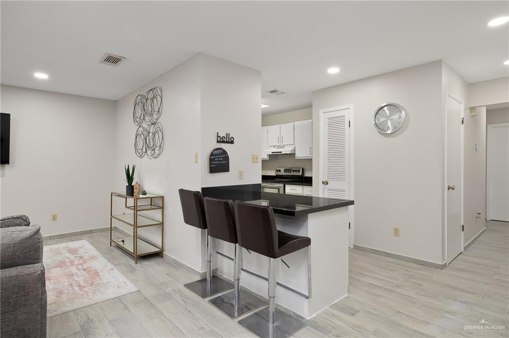 500 East El Rancho Avenue, Unit 36 McAllen, TX 78503 - Photo 7 of 16 a view of kitchen with cabinets and wooden floor
