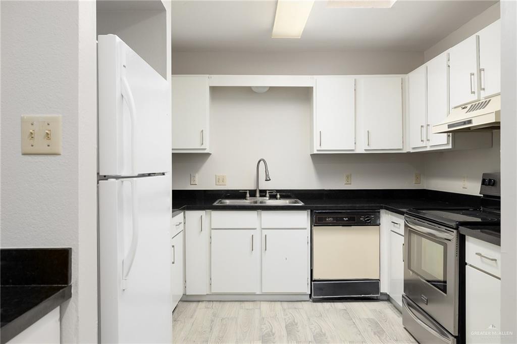500 East El Rancho Avenue, Unit 36 McAllen, TX 78503 - Photo 8 of 16 a kitchen with stainless steel appliances granite countertop a refrigerator and white cabinets