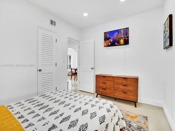 a bedroom with a bed and a dresser