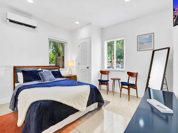a spacious bedroom with a bed and a table in it