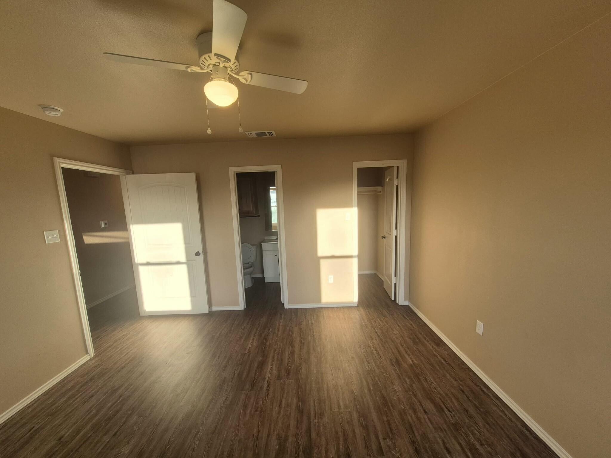 2506 Avenue P Lubbock, TX 79411 - Photo 5 of 11 a view of an empty room with wooden floor and a window