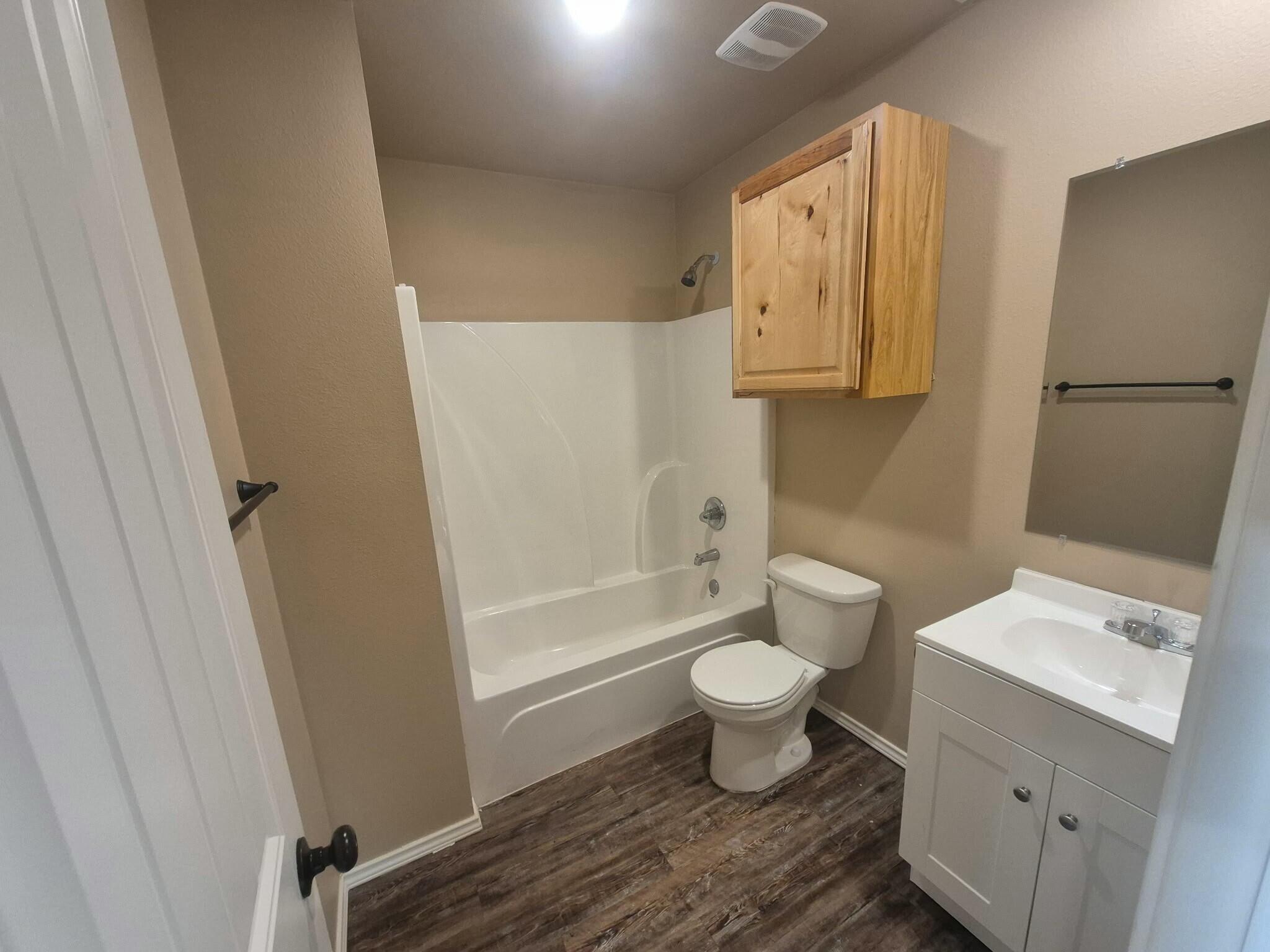 2506 Avenue P Lubbock, TX 79411 - Photo 7 of 11 a bathroom with a sink toilet and shower