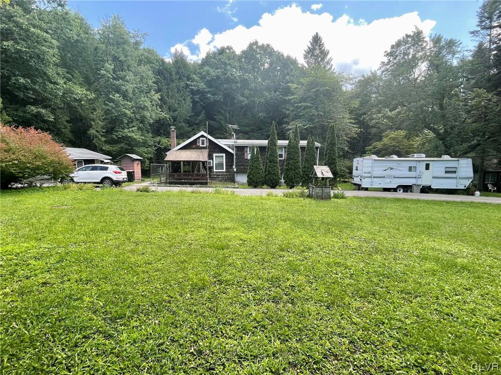 124 Haney Road Kunkletown, PA 18058 - Photo 2 of 24 a view of a house with a big yard and large trees