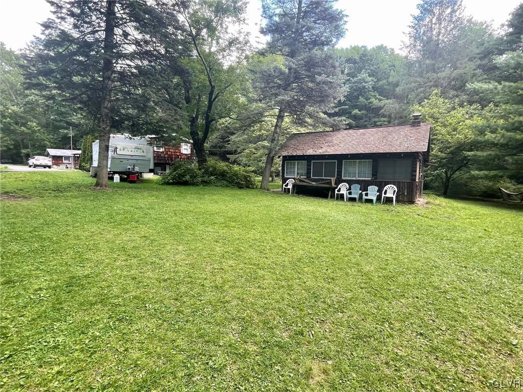 124 Haney Road Kunkletown, PA 18058 - Photo 22 of 24 a view of a house with backyard sitting area and garden