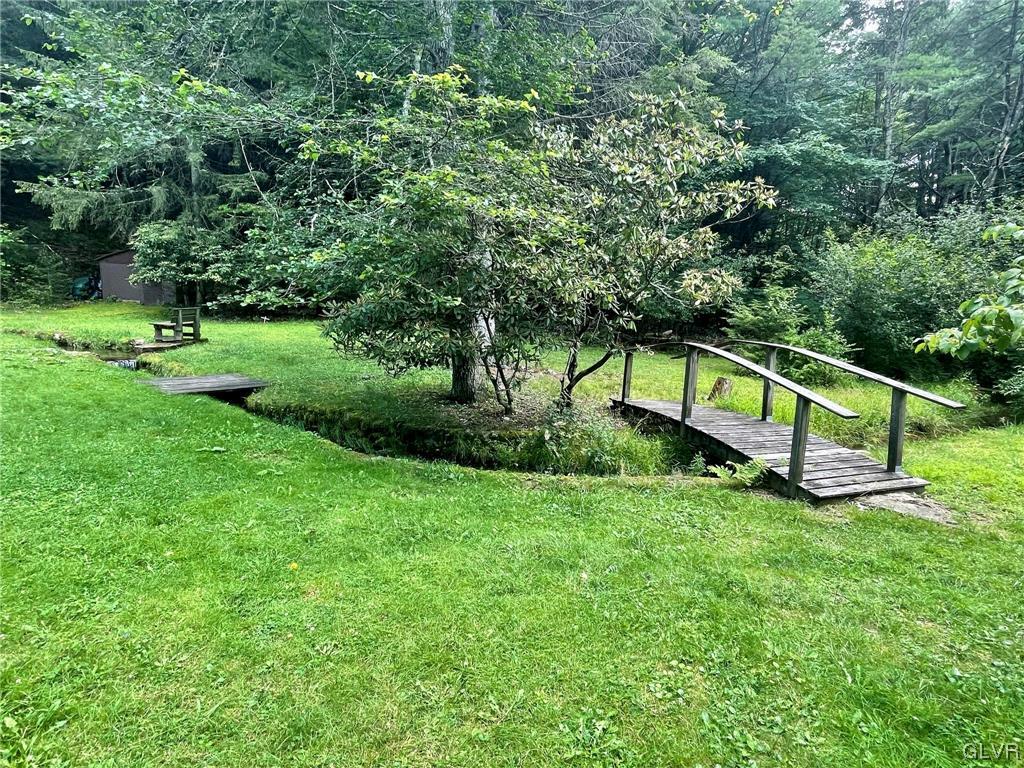 124 Haney Road Kunkletown, PA 18058 - Photo 3 of 24 a view of a garden with a bench