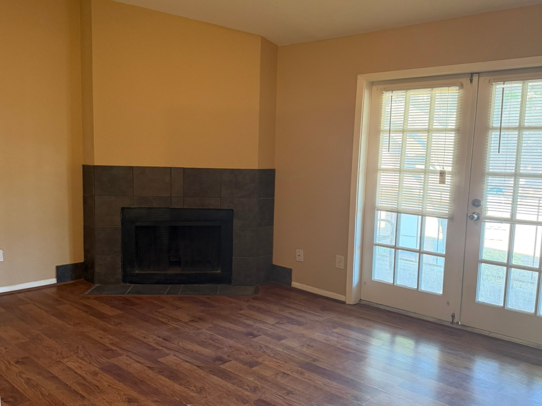 9000 Bissonnet Street, Unit 512 Houston, TX 77074 - Photo 2 of 13 wooden floor fireplace and windows in an empty room