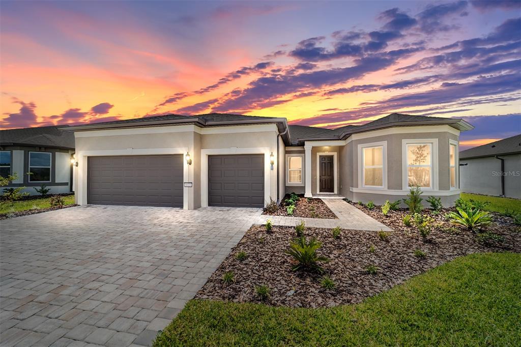 8618 Southwest 61st Loop Ocala, FL 34481 - Photo 1 of 1 a front view of a house with a yard