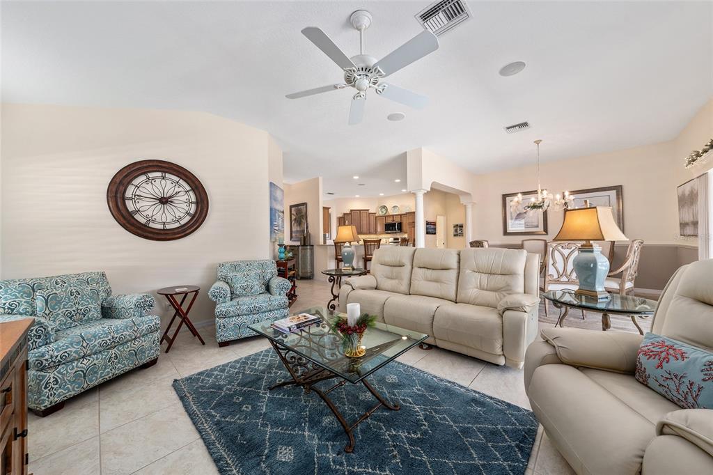 2416 Boiling Springs Court The Villages, FL 32162 - Photo 25 of 41 a living room with furniture a clock and a rug