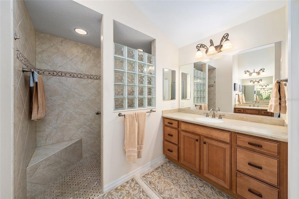 2416 Boiling Springs Court The Villages, FL 32162 - Photo 29 of 41 a spacious bathroom with a double vanity sink a large mirror and shower