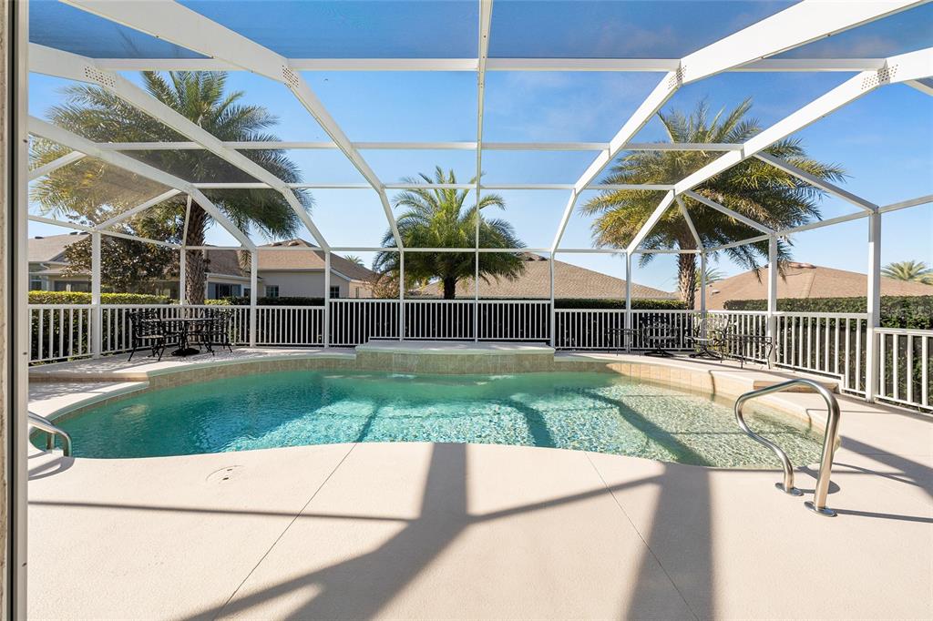2416 Boiling Springs Court The Villages, FL 32162 - Photo 36 of 41 a view of a backyard with couches under an umbrella