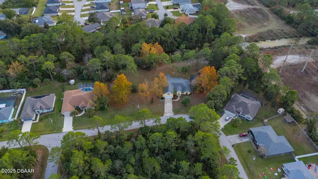 an aerial view of a house with a yard and lake view