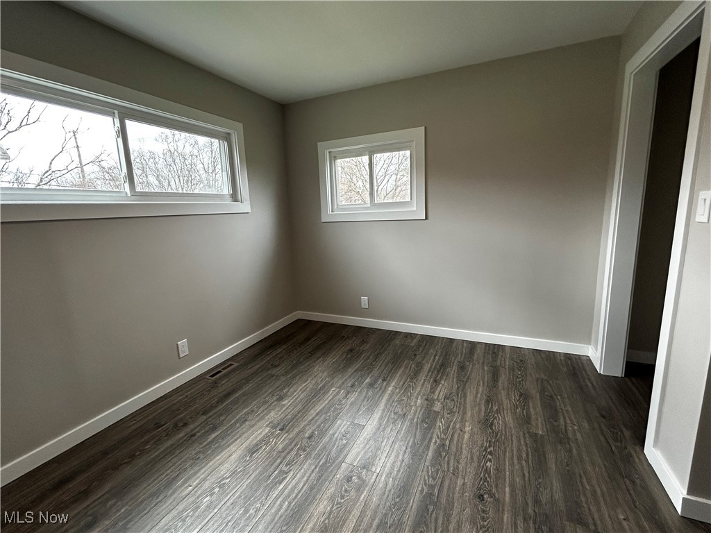 3465 Ridge Road Zanesville, OH 43701 - Photo 8 of 16 Unfurnished bedroom featuring baseboards, visible vents, and dark wood-style flooring