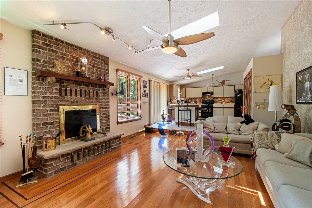 85 Stover Road Chili, NY 14624 - Photo 16 of 41 the rear gathering room - SKY LIGHTS and a FIREPLACE TOO!