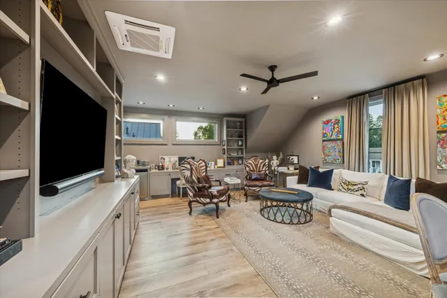 a living room with lots of furniture and a flat screen tv