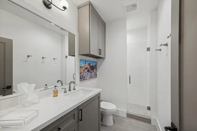 a bathroom with a sink toilet and shower