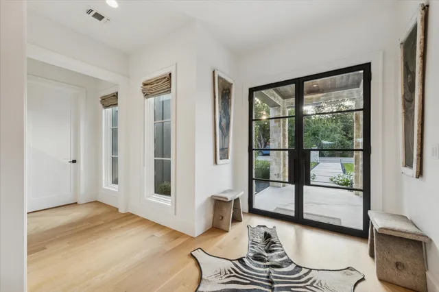 a living room with hardwood floor and a large window