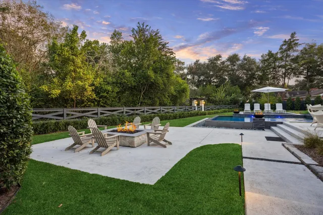 a view of a patio with table and chairs under an umbrella