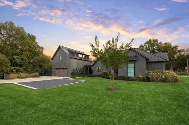 a front view of house with yard and green space