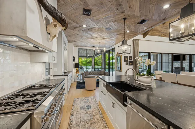 a kitchen with sink stove and cabinets