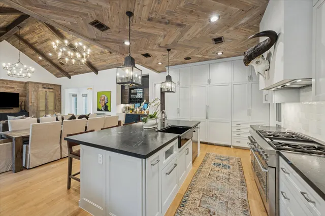 a kitchen that has a lot of cabinets a sink and a stove