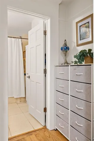 a view of a closet with wooden floor