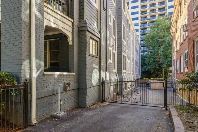 a view of a brick house with many windows