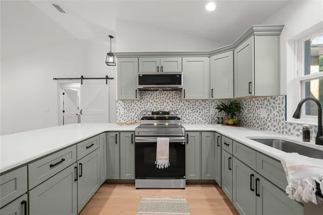 a kitchen with a sink stove and cabinets