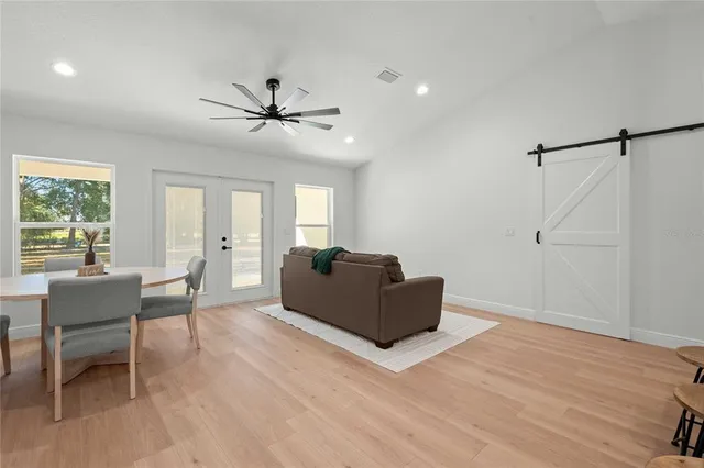 a living room with furniture and a ceiling fan