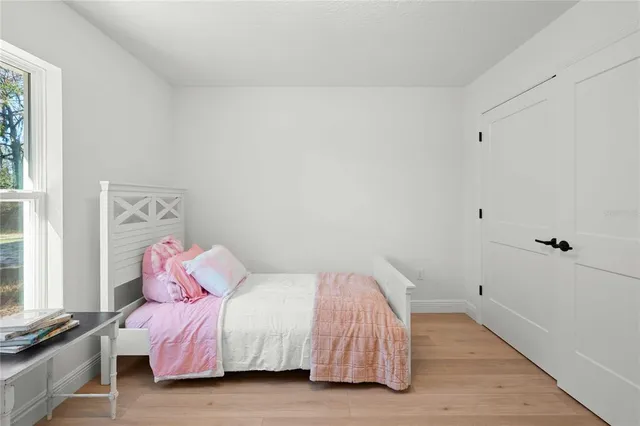 a bedroom with a bed and a window